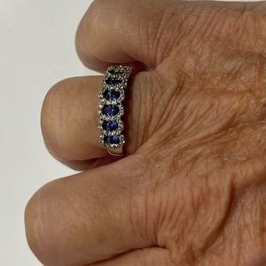 Sterling silver with blue topaz and CZ stones.